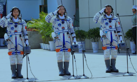 Liu Yang, Jing Haipeng, and Liu Wang, the three astronauts for the space voyage on the spacecraft Shenzhou-9, salute before their departure at the Jiuquan Satellite Launch Center in Jiuquan in northwest China’s Gansu province